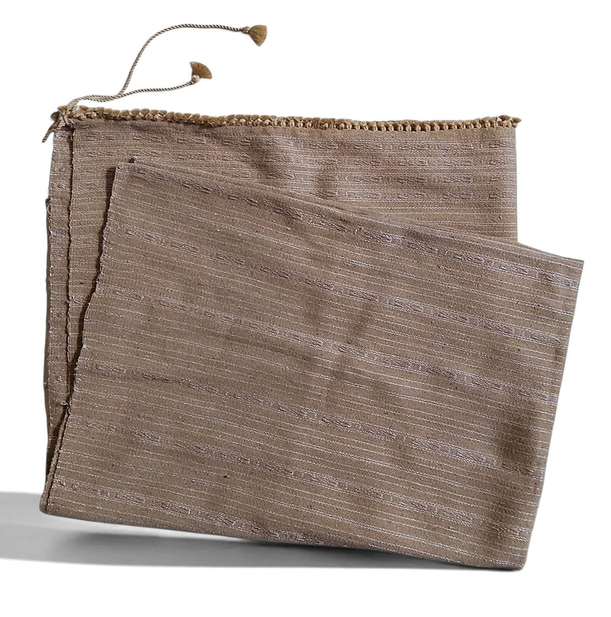 Honnihonjeng Pekok Toss Muga silk fabric in golden beige with delicate zari stripes and decorative tassel trim