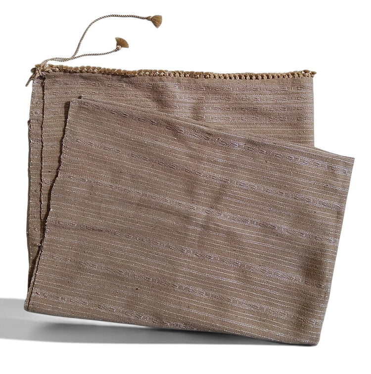 Honnihonjeng Pekok Toss Muga silk fabric in golden beige with delicate zari stripes and decorative tassel trim