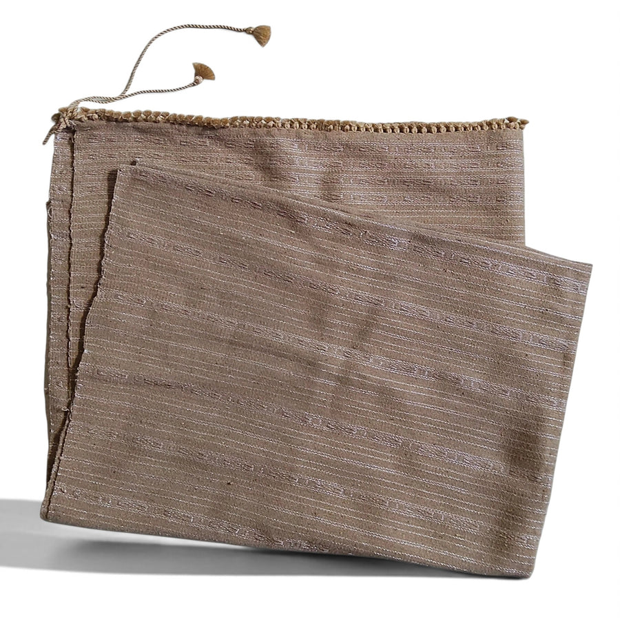 Honnihonjeng Pekok Toss Muga silk fabric in golden beige with delicate zari stripes and decorative tassel trim